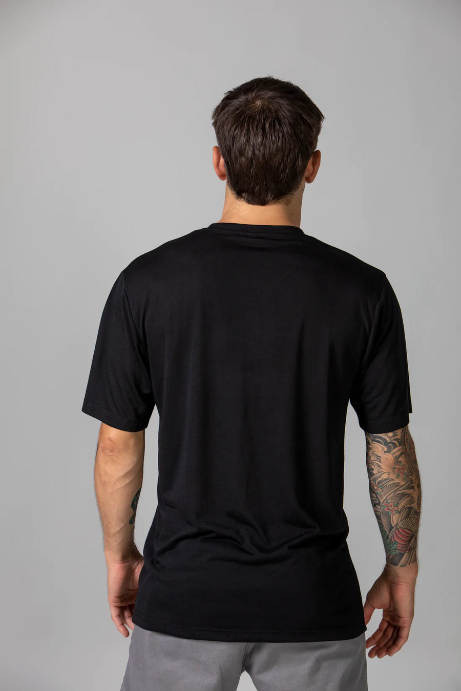 Back of Pedro in our classic sustainable t-shirt in Onyx.